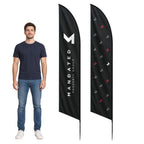A man wearing a navy blue t-shirt and jeans stands next to two black feather-style flags on a white background. One flag displays a large white 'M' logo with the text 'MANDATED PROPERTY GROUP' vertically printed in white.